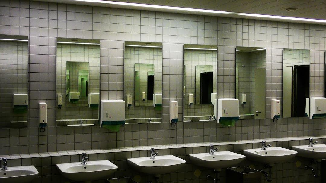 Why Restroom Mirrors Fail at the Frame Before the Glass